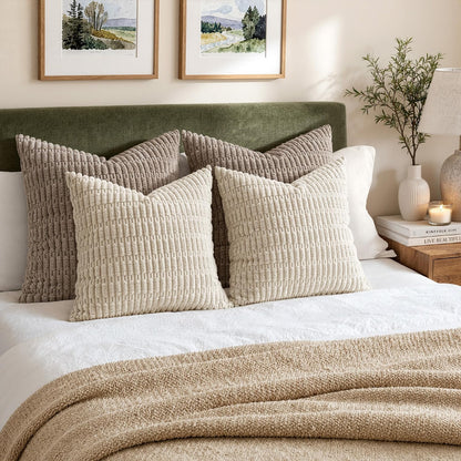 Textured corduroy pillow covers styled on a bed with warm candle light